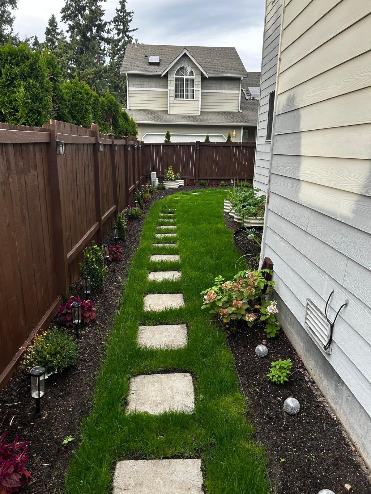 Tidy side yard with stepping stones and fresh lawn