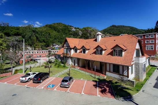 Vista aérea do coworking, estacionamento e área arborizada