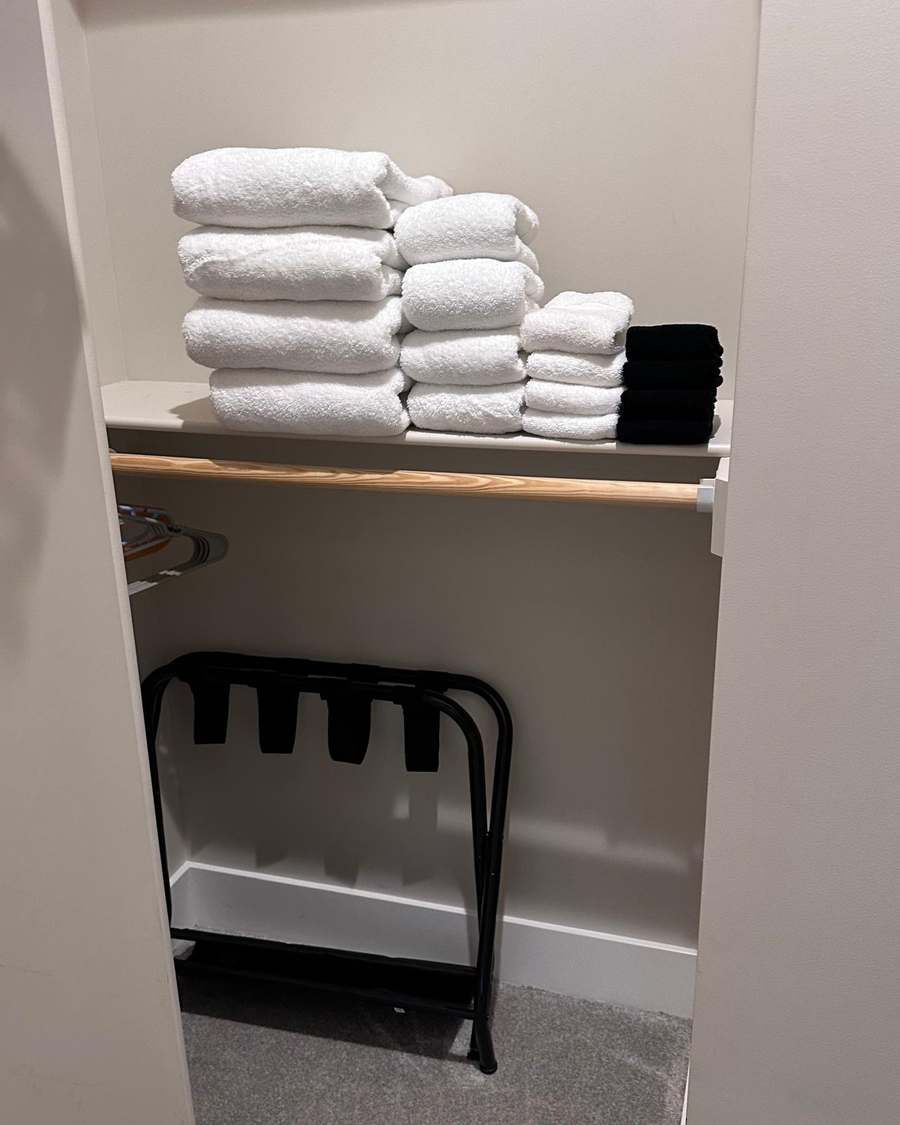 Fresh towels folded and stocked during an Airbnb turnover