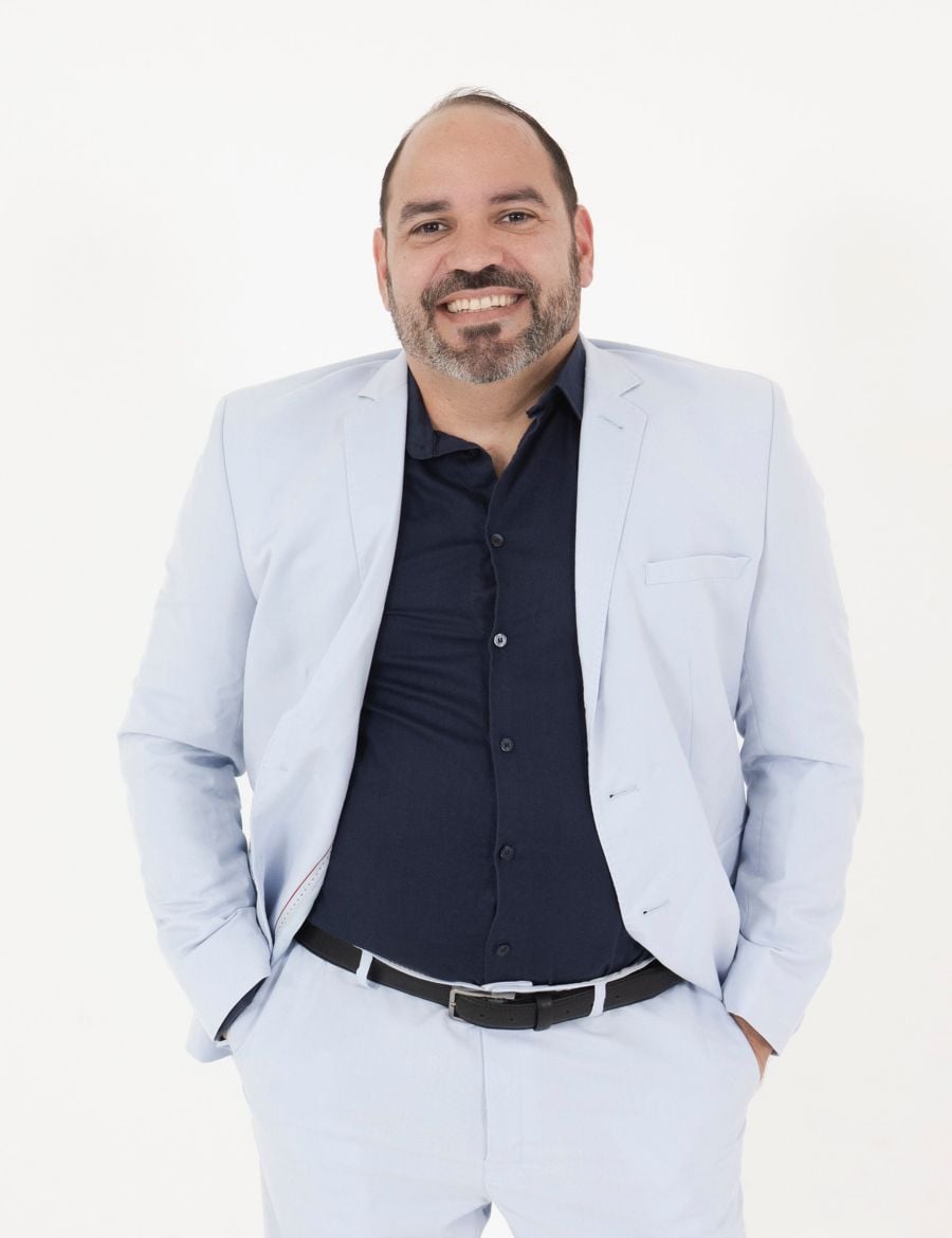 Guga Pessoas sorrindo, de terno claro